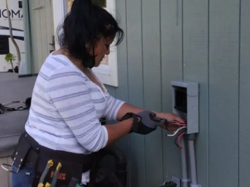 Licensed electrician wiring an exterior subpanel in Asbury Park